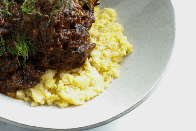 Mediterranean Short Ribs with Polenta - This recipe is super impressive yet really easy to make. It has a surprising secret ingredient that makes all the difference. | circleofeaters.com