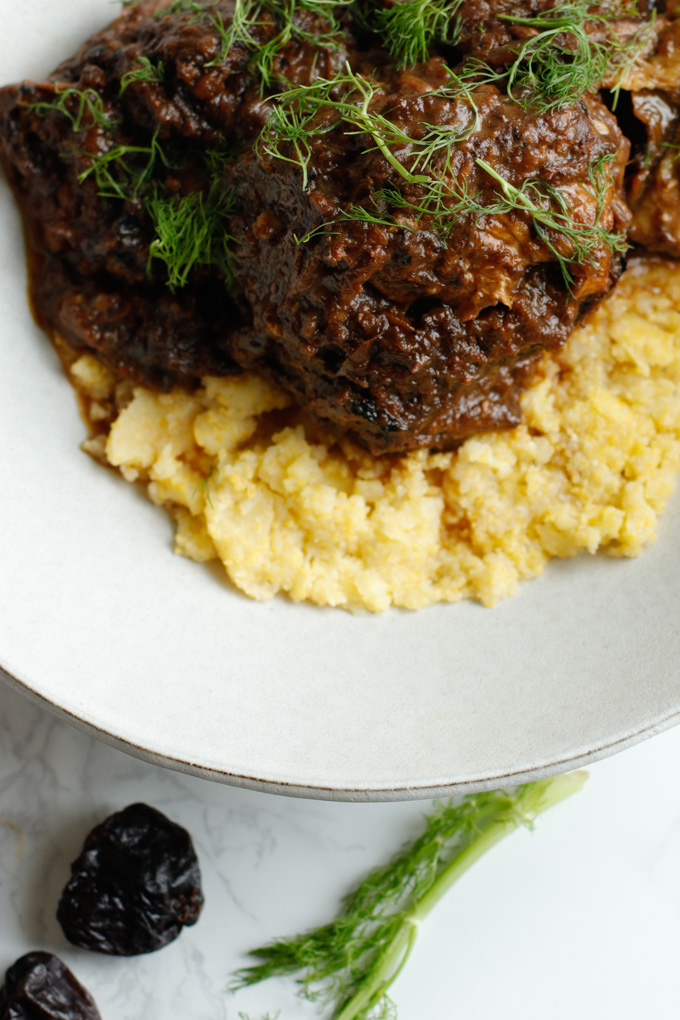 Mediterranean Short Ribs with Polenta - This recipe is super impressive yet really easy to make. It has a surprising secret ingredient that makes all the difference. | circleofeaters.com