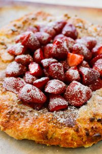 Strawberry Pistachio Tart - a double layer of strawberries with a pistachio frangipane make this tart sublime! Oh, let's not forget the sour cream crust. | circleofeaters.com