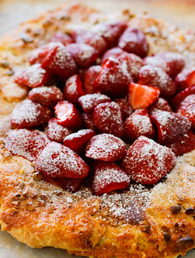Strawberry Pistachio Tart - a double layer of strawberries with a pistachio frangipane make this tart sublime! Oh, let's not forget the sour cream crust. | circleofeaters.com