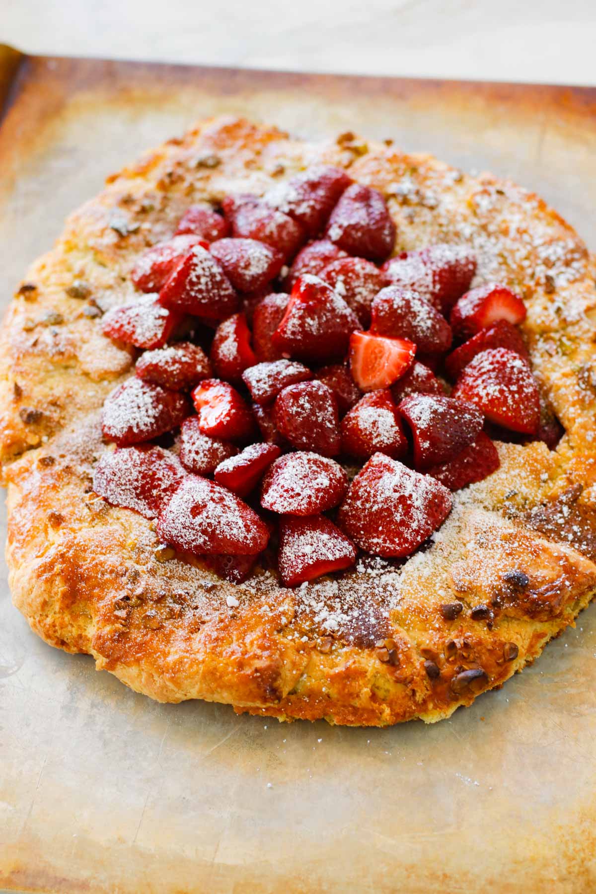 Strawberry Pistachio Tart - a double layer of strawberries with a pistachio frangipane make this tart sublime! Oh, let's not forget the sour cream crust. | circleofeaters.com